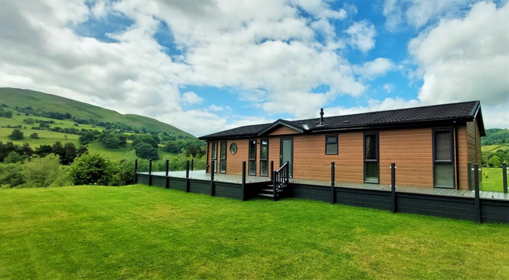 Maes Mynan Lodge is a 51' x 22' bespoke luxury lodge for sale on Maes Mynan Lodge Park in North Wales. Spectacular views from the wrap around deck.