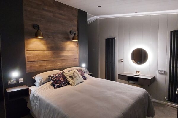 Boutique bedroom with floating wall in this luxury bespoke lodge for sale on Maes Mynan Lodge Park in North Wales