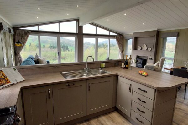 Bespoke luxury lodge for sale at Maes Mynan Park in North Wales | Lakeside position overlooking Clwydian Range and woodland.