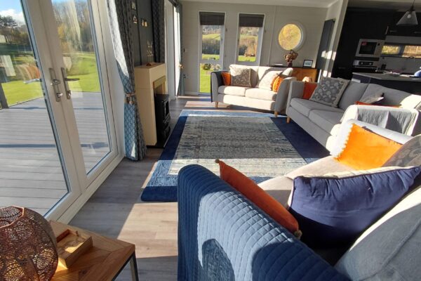 Luxurious comfort in this large bespoke lodge for sale in North Wales. Stunning countryside and lakeside views at Maes Mynan Holiday Park