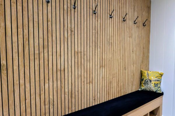 Interior detail of wood panel finish and art deco style coat hooks in luxury lodge for sale on Maes Mynan Park in North Wales by YourRetreats