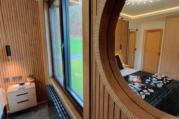 Softly lit bedroom interior in North Wales lodge for sale