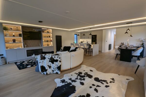 Curved sofa and full glass frontage in lakeside lodge for sale