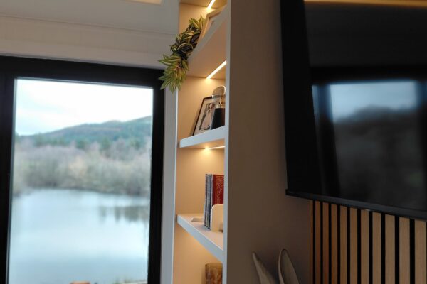 Built-in shelving and recessed TV in bespoke country holiday home at Maes Mynan Park for sale in North Wales | YourRetreats