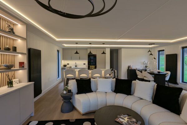 Curved sofa in Scandi design lakeside lodge for sale | Maes Mynan Park | YourRetreats