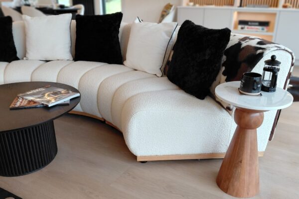 Solhare Lodge lounge - close up of curved sofa - Maes Mynan Park - YourRetreats